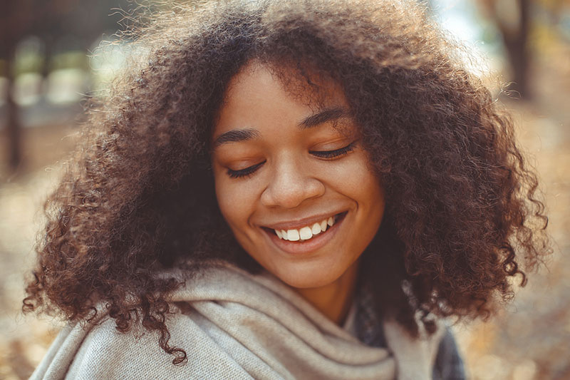 young woman thinking about her dental care Dental Care at Sweetwater Sugar Land TX