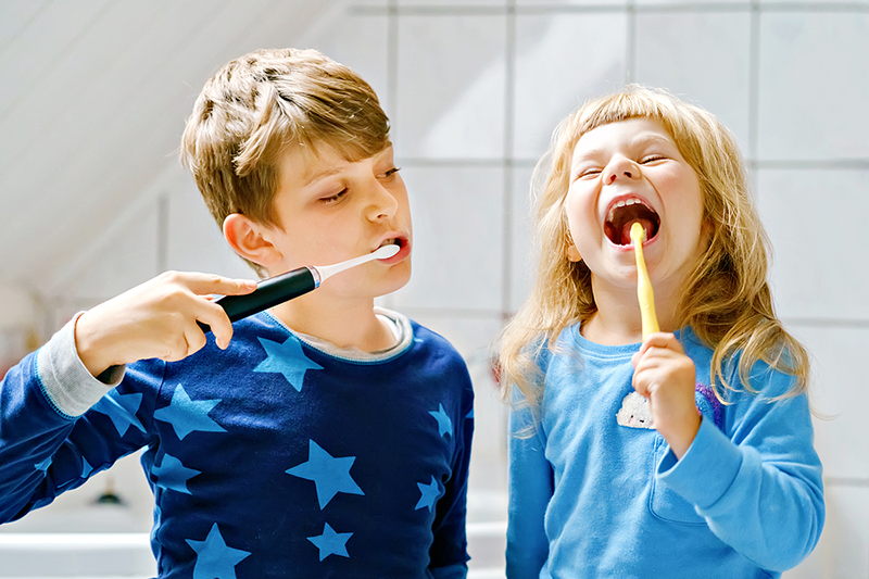 Two kids brushing their teeth Dental Care at Sweetwater Sugar Land TX