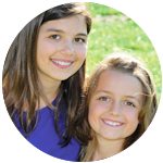 Two young girls smiling.